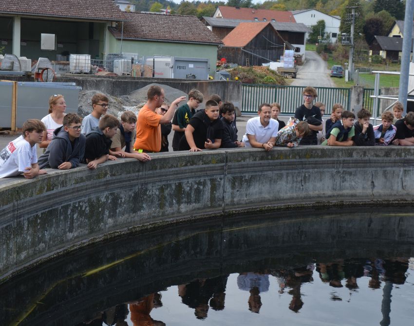 Gruppe von Schüler:innen vor einem Klärbecken